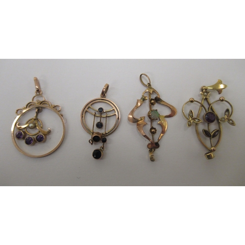 117 - Four gold coloured metal open frame pendants, variously set with coloured stones 