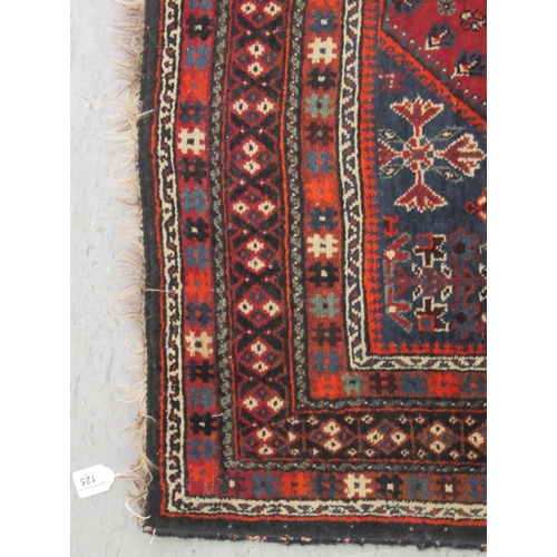 125 - A Shiraz rug, decorated with symmetrical stylised designs, on a multi-coloured ground  47