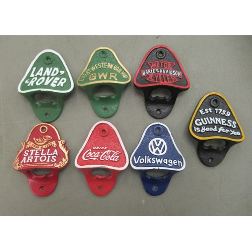 130 - Seven cast metal wall mounted bottle openers, bearing various advertising logos 