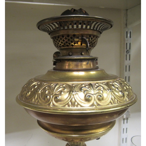 187 - A late Victorian gilt metal oil lamp of urn design, raised on scrolled legs  19