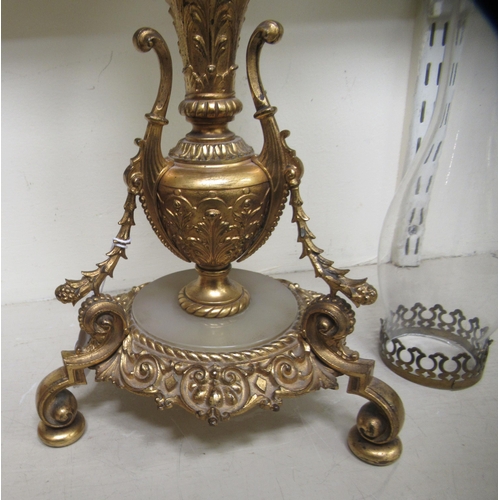 187 - A late Victorian gilt metal oil lamp of urn design, raised on scrolled legs  19