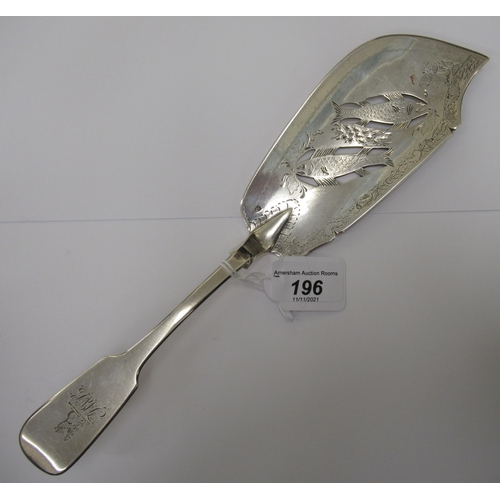 196 - An Irish silver fiddle pattern fish slice, the blade pierced, engraved and chased with fish amid flo... 