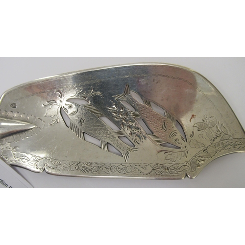 196 - An Irish silver fiddle pattern fish slice, the blade pierced, engraved and chased with fish amid flo... 