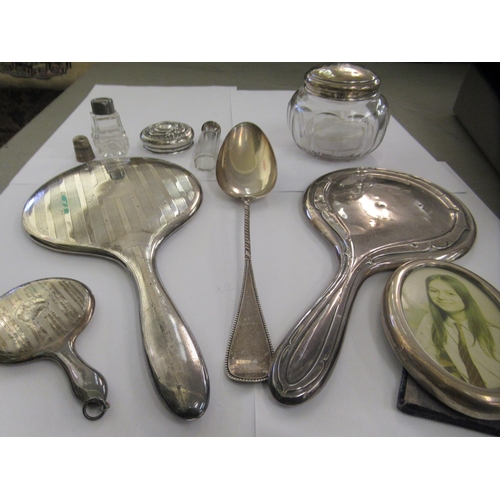 198 - Silver and silver coloured metal items: to include two hand mirrors; a powder jar; and serving spoon... 