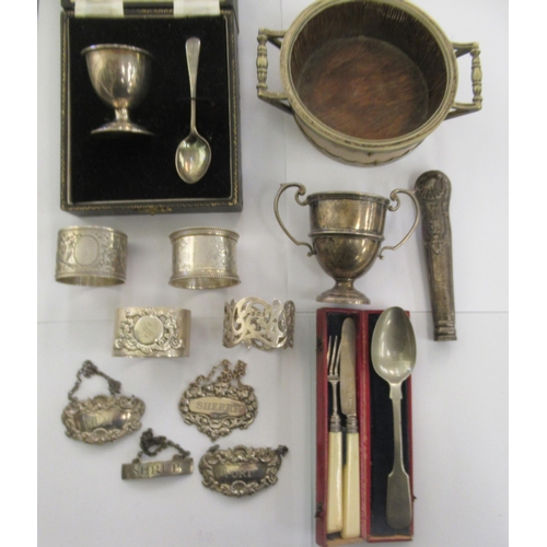 203 - Silver, white metal and other items: to include a 19thC 'Shrub' wine label; a twin handled coaster; ... 