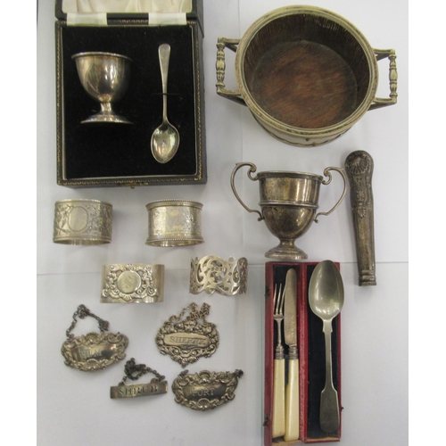 203 - Silver, white metal and other items: to include a 19thC 'Shrub' wine label; a twin handled coaster; ... 