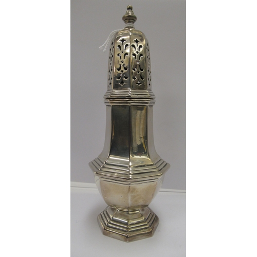 211 - A silver caster of octagonal, pedestal vase design with a domed, perforated cover and finial  Cooper... 