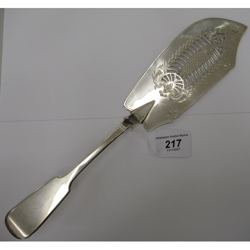 217 - A William IV silver fiddle pattern fish slice, the blade pierced, engraved and chased with a fish am... 