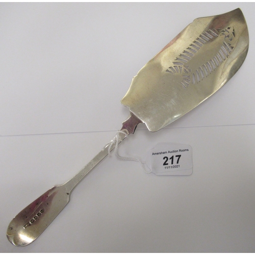 217 - A William IV silver fiddle pattern fish slice, the blade pierced, engraved and chased with a fish am... 