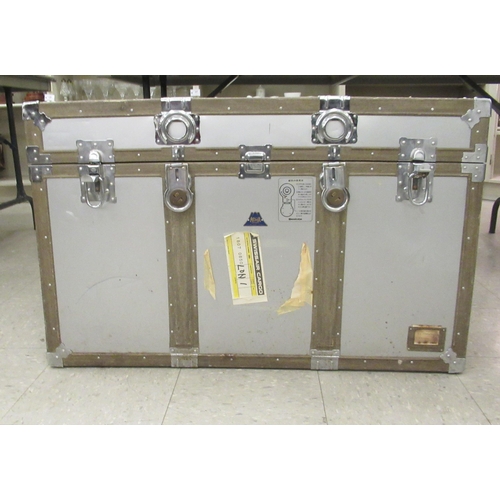 225 - A modern re-enforced and riveted alloy trunk with clasps and flank carrying handles  23