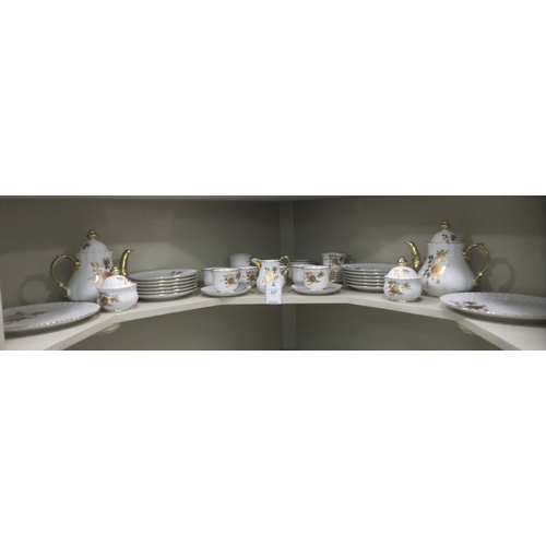 227 - A German ivory glazed and gilded porcelain tea set  comprising twelve place setting including t... 