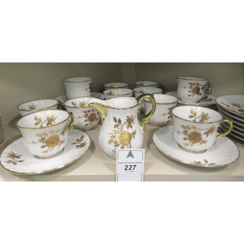 227 - A German ivory glazed and gilded porcelain tea set  comprising twelve place setting including t... 