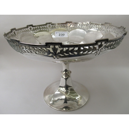 230 - A lobed silver cake dish with a uniformly pierced and stepped rim, elevated on a waisted, conical fo... 