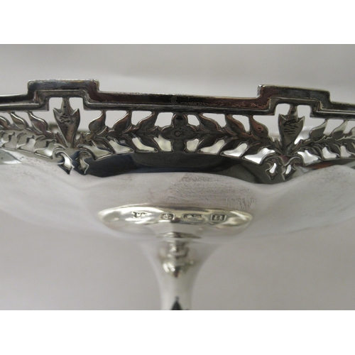 230 - A lobed silver cake dish with a uniformly pierced and stepped rim, elevated on a waisted, conical fo... 