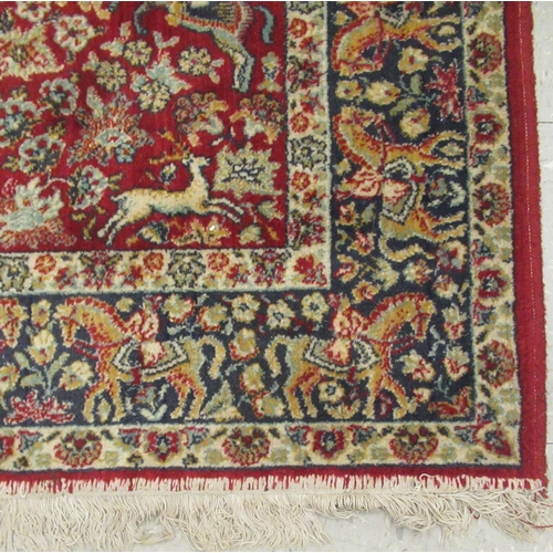 232 - A Kashan rug, with floral motifs and figures on horse back, on a red and blue ground  50