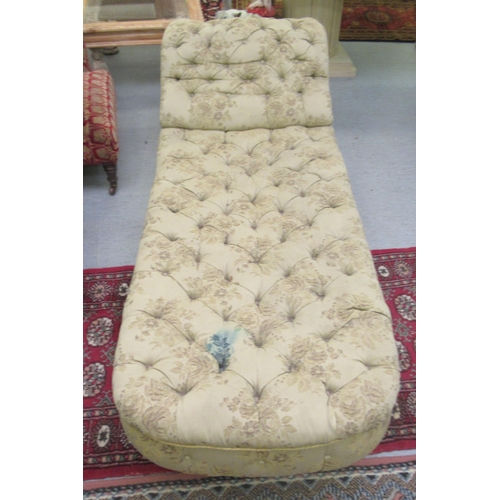 234 - A late Victorian chaise longue, button upholstered in a charcoal floral patterned fabric, raised on ... 