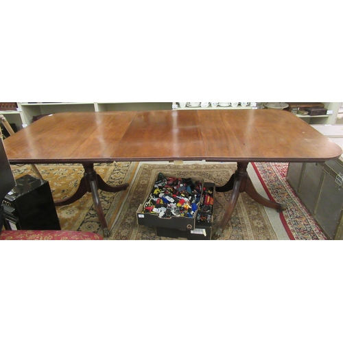 238 - An early 20thC Regency style mahogany dining table, raised on twin pedestals with splayed sabre legs... 