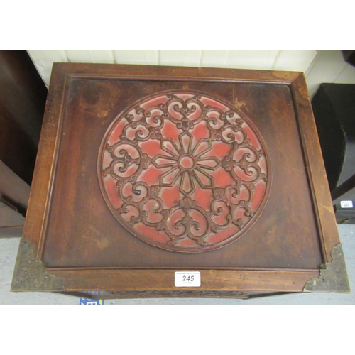 245 - A modern Asian inspired fruitwood box with ornate panelled ornament, on a plinth  20