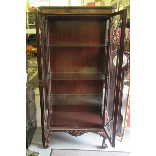 250 - A mid 20thC mahogany display cabinet with two astragal glazed doors, raised on cabriole legs, talon ... 