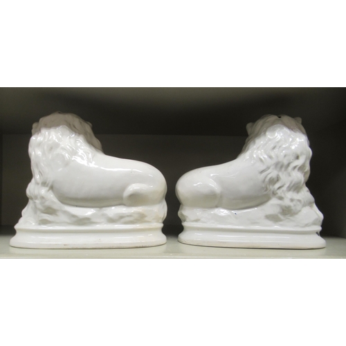 262 - A pair of early 20thC Staffordshire china seated lions, on oval plinths  10