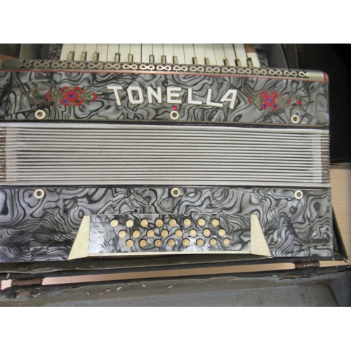 265 - A Tonela twenty-four key grey marble effect cased piano accordion 