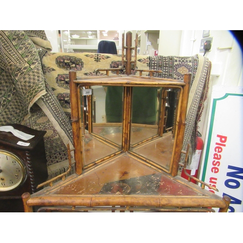 268 - An early/mid 20thC bamboo framed corner unit, having a mirrored upstand, over an open shelf and anot... 