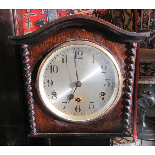 270 - A 1930s oak cased granddaughter clock; the 8 day movement faced by a silvered Arabic dial  50