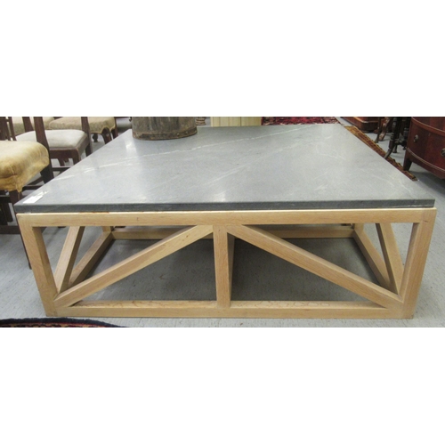 65 - A modern light oak framed coffee table with a grey mottled marble top  17