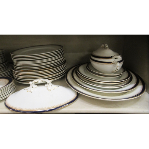 67 - Wedgwood and similar china tableware, decorated with blue/dark blue and gilt banding