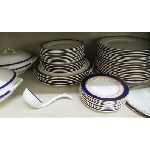 67 - Wedgwood and similar china tableware, decorated with blue/dark blue and gilt banding