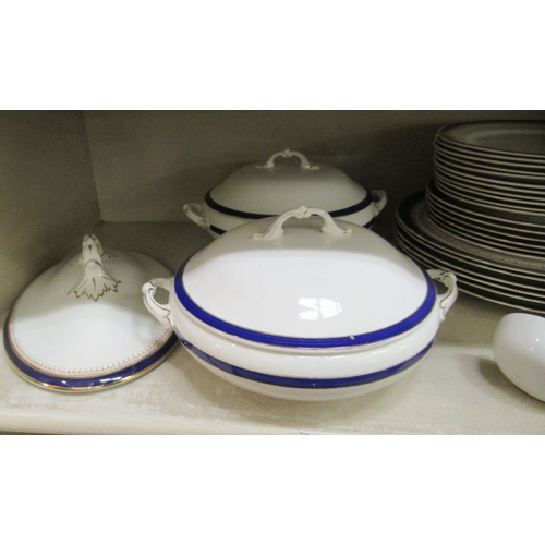 67 - Wedgwood and similar china tableware, decorated with blue/dark blue and gilt banding