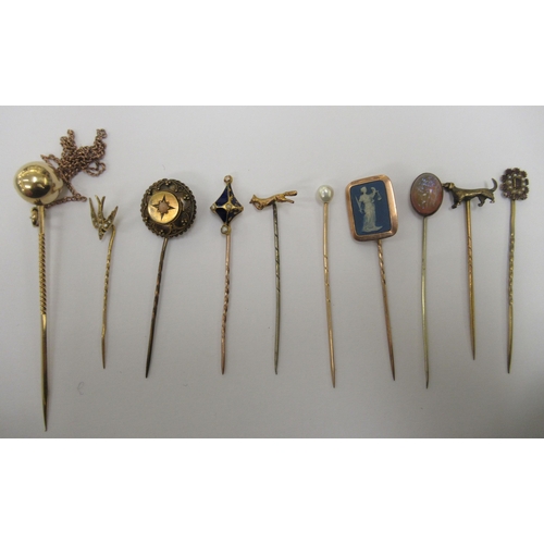 78 - Nine gold coloured metal stickpins: to include one set with a blue jasper stoneware tablet, featurin... 