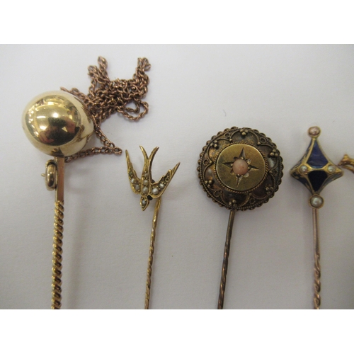 78 - Nine gold coloured metal stickpins: to include one set with a blue jasper stoneware tablet, featurin... 