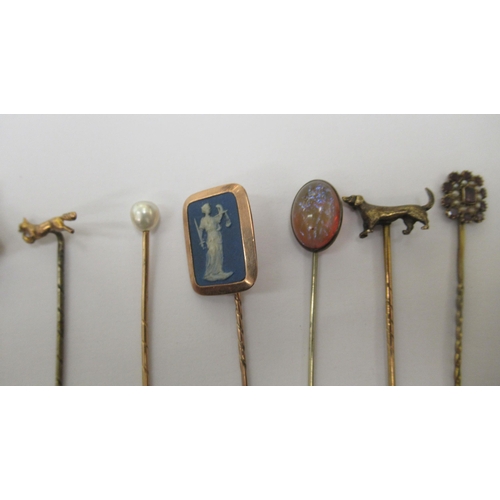 78 - Nine gold coloured metal stickpins: to include one set with a blue jasper stoneware tablet, featurin... 