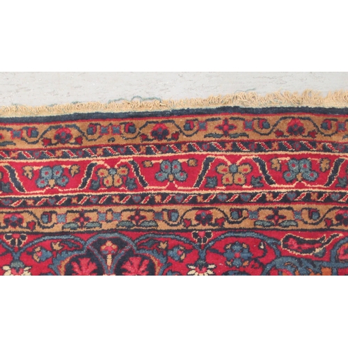 89 - A Kashan rug, decorated with stylised foliate designs, on a dark blue ground  53