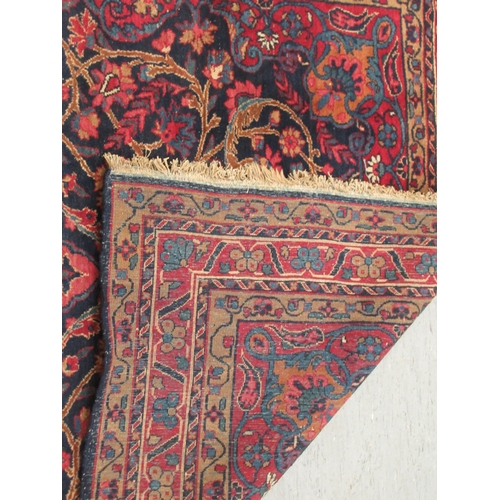 89 - A Kashan rug, decorated with stylised foliate designs, on a dark blue ground  53