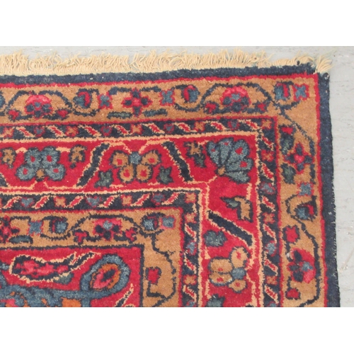 90 - A Kashan rug, decorated with stylised foliate designs, on a dark blue ground  53