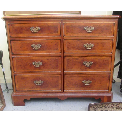 92 - A modern yew finished record cabinet with two doors and a hinged lid, raised on bracket feet  33