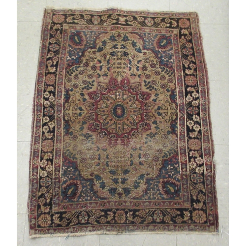 99 - A Kashan rug, decorated with flora and other ornament, on a red and blue ground 40