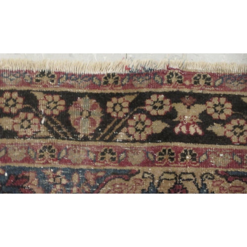 99 - A Kashan rug, decorated with flora and other ornament, on a red and blue ground 40