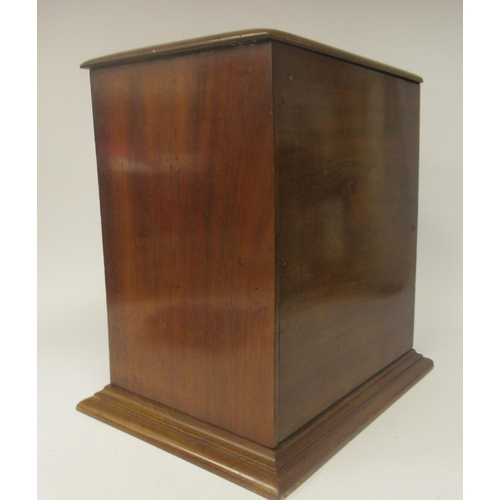 11 - An early 20thC mahogany desktop post box with a domed top, straight sides and a lockable hinged door... 