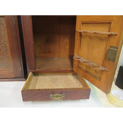 127 - A late 19th/early 20thC stained pine hanging cabinet, the relief carved panelled door enclosing an a... 