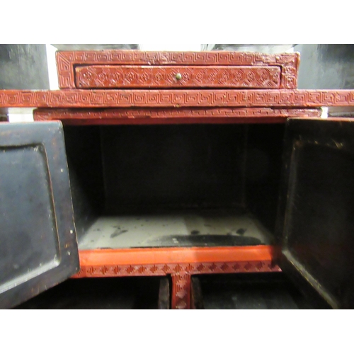 136 - A 19thC Chinese cinnabar table cabinet with a scholar's cap superstructure, on a Ming style base, fe... 