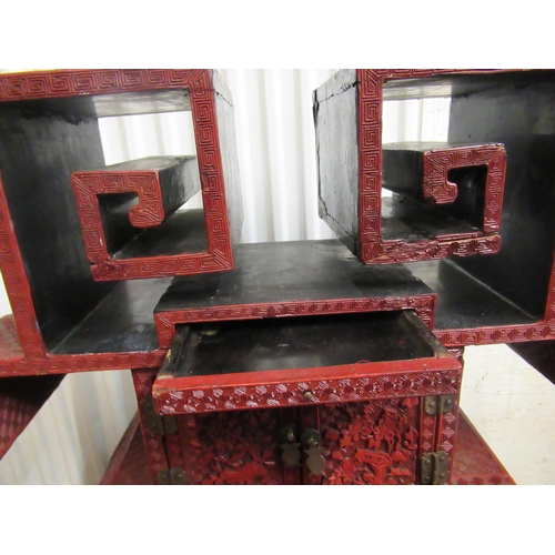 136 - A 19thC Chinese cinnabar table cabinet with a scholar's cap superstructure, on a Ming style base, fe... 