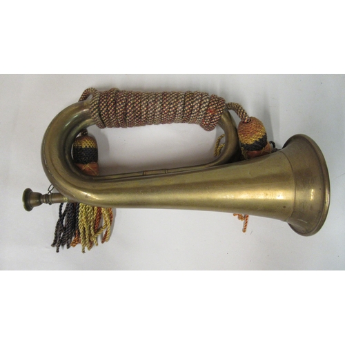 140 - A military style brass bugle with a tasselled cord; a huntsman's coiled copper and brass horn; and a... 