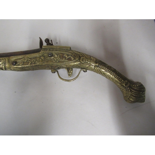 143 - A pair of decoratively cast brass and steel flintlock pistols&nbsp; approx 19