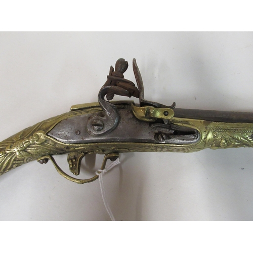 143 - A pair of decoratively cast brass and steel flintlock pistols&nbsp; approx 19