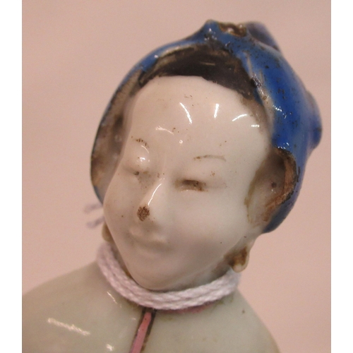 149 - A mid 18th Chinese famille rose porcelain standing figure, a market trader holding a money belt&nbsp... 
