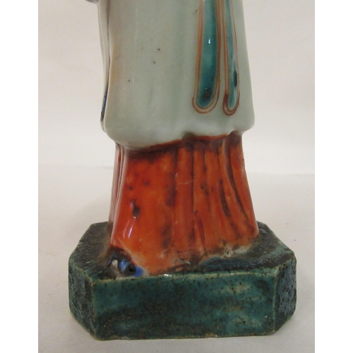 149 - A mid 18th Chinese famille rose porcelain standing figure, a market trader holding a money belt&nbsp... 