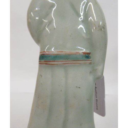 149 - A mid 18th Chinese famille rose porcelain standing figure, a market trader holding a money belt&nbsp... 